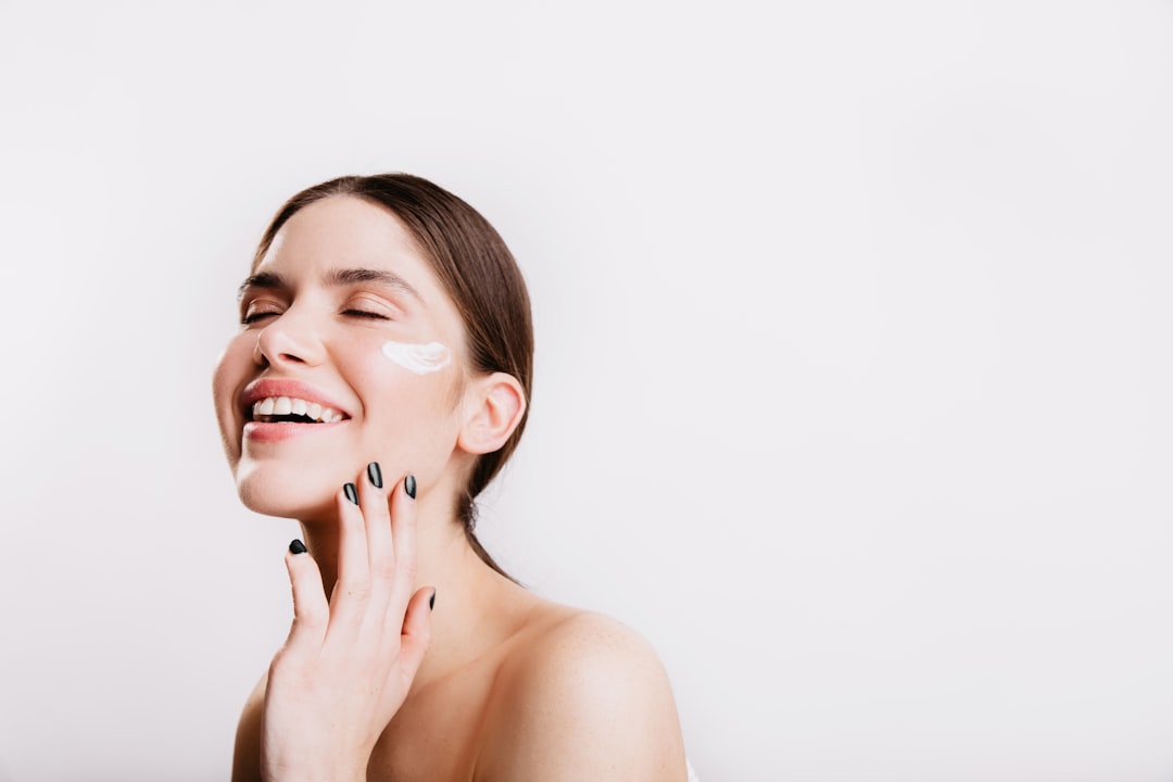 a-woman-smiles-while-she-holds-her-hand-to-her-face-tqspgnqeco8